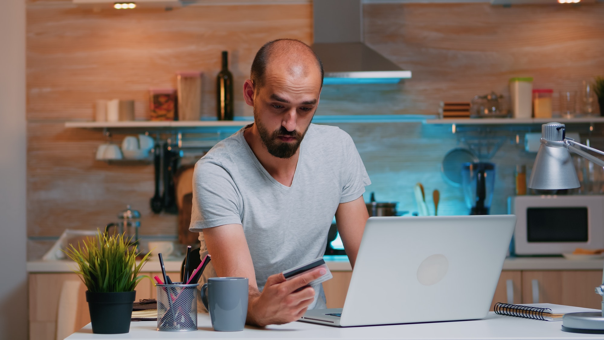 Man shopping online late at night using credit card